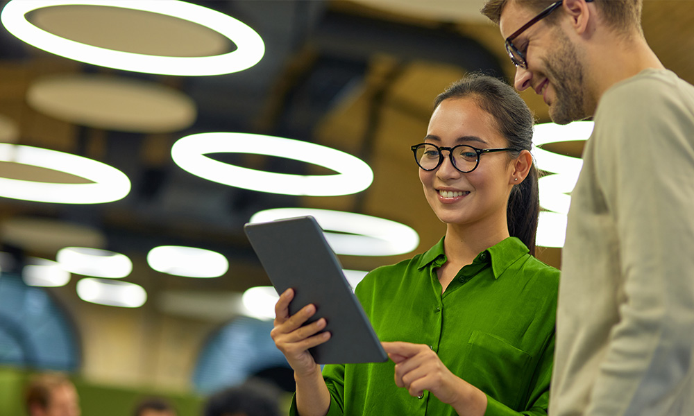 Man and woman talking with tablet